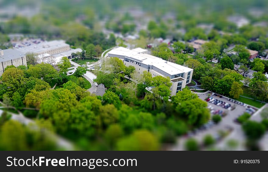 A tilt-shift view of buildings near a park in city. A tilt-shift view of buildings near a park in city.