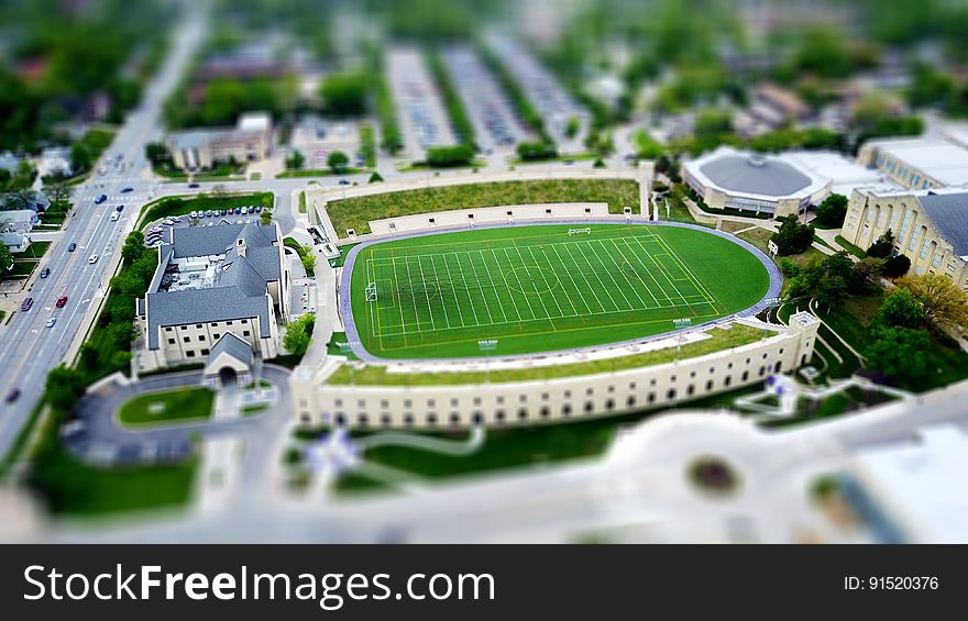 A model of a college building with a soccer field. A model of a college building with a soccer field.