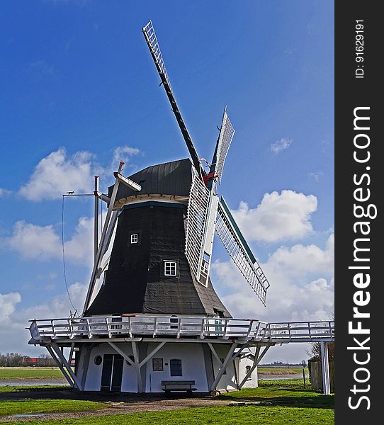 White and Black Wooden Windmill during Daytime