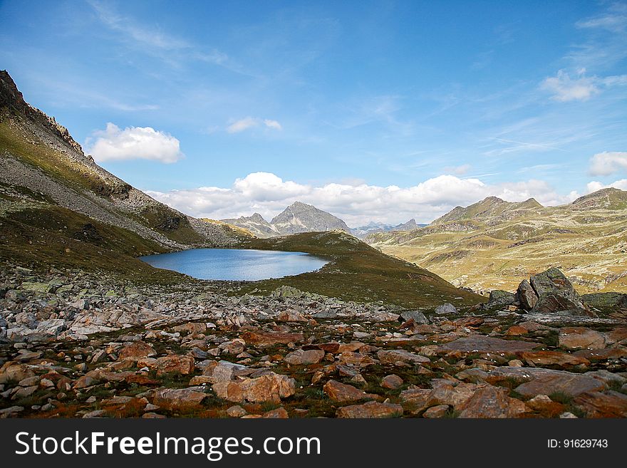 Scenic View Of Mountains Against Blue Sky