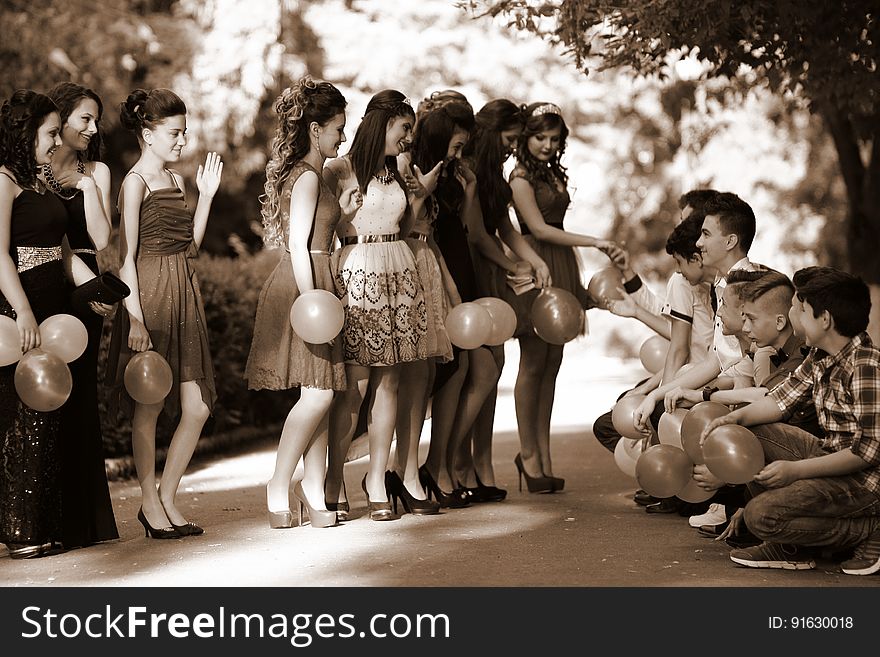 A group of teenagers in a school dance or graduation celebration.
