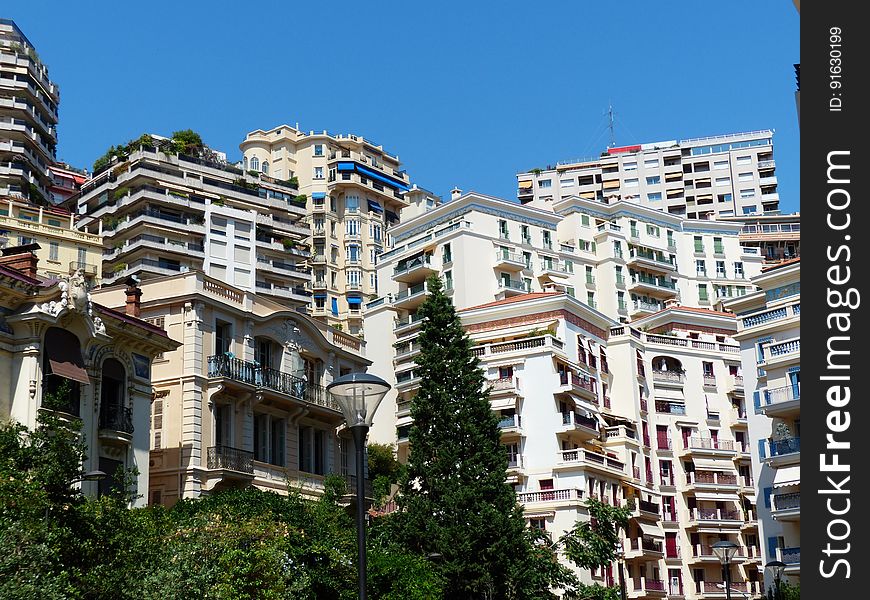 A view of a city with apartment blocks on the hillside.