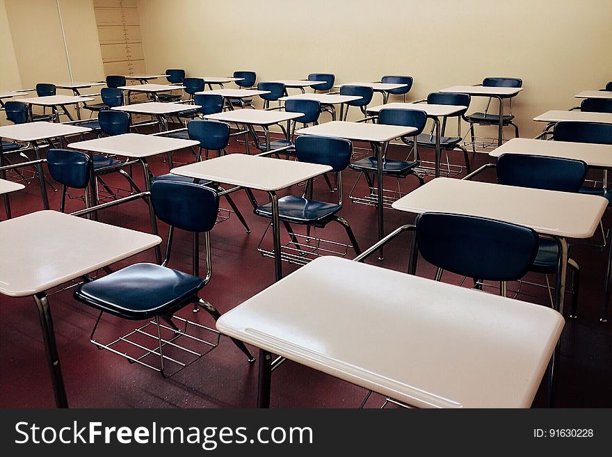 Student Desks And Chairs In Classroom