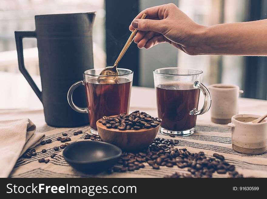 Person brewing coffee in the morning.