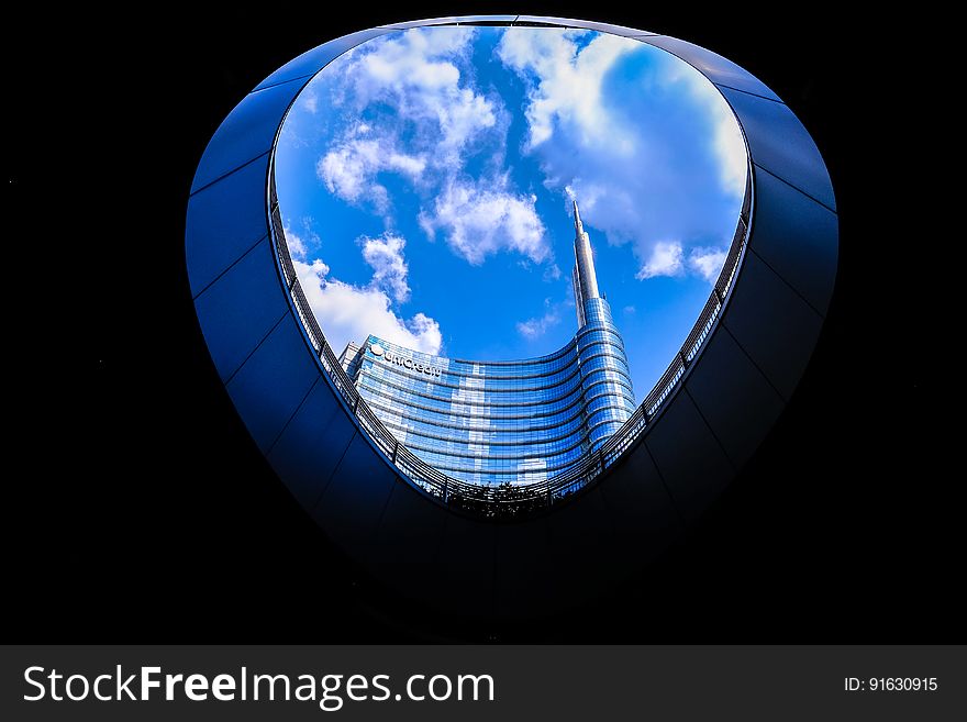 Blue sky seen through an opening in a modern building.