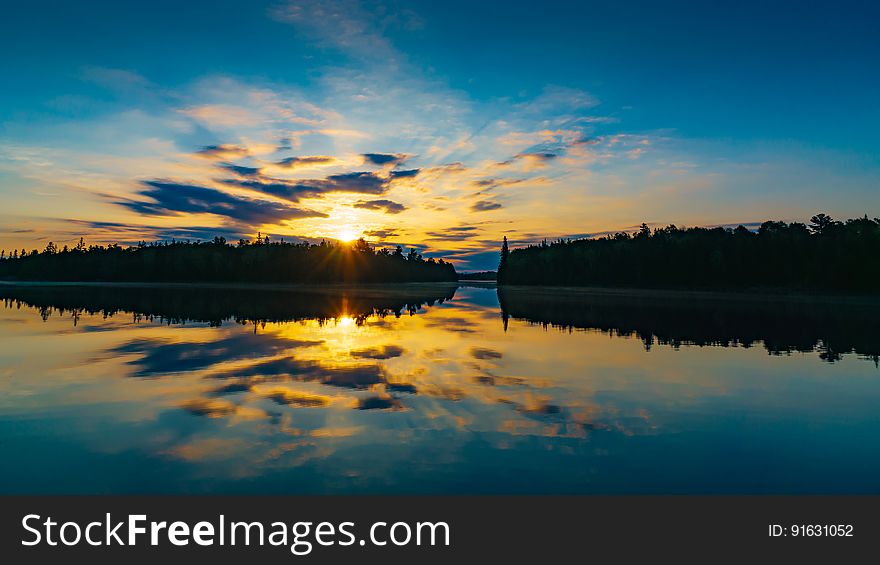 A scenic lake reflects the dawn sky. A scenic lake reflects the dawn sky.