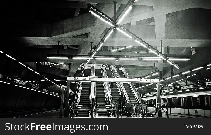 A view inside a subway station in black and white.