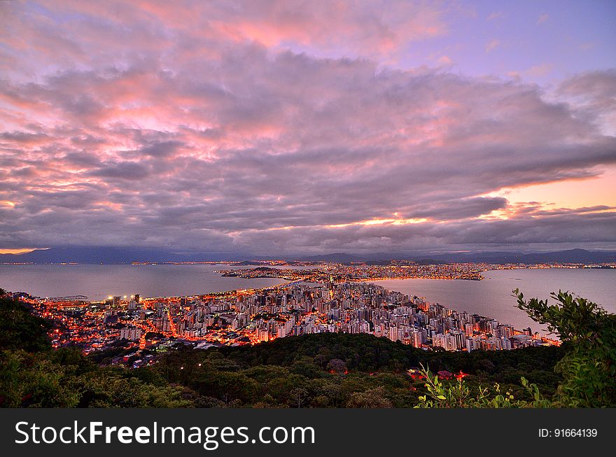 Photo of City Buildings Taken Up on the Mountain during Dusk