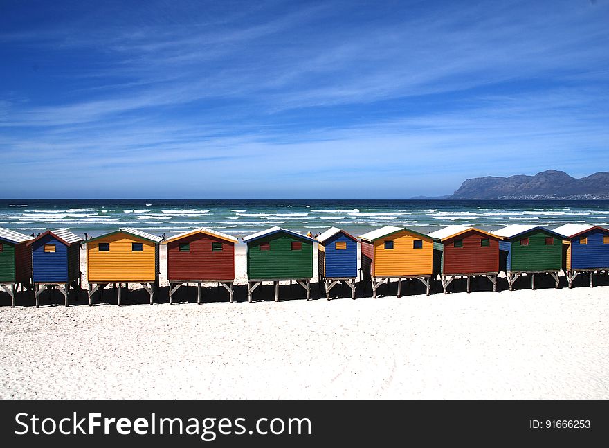 Colorful Cottages Near the Sea Under Blue Sky during Daytime