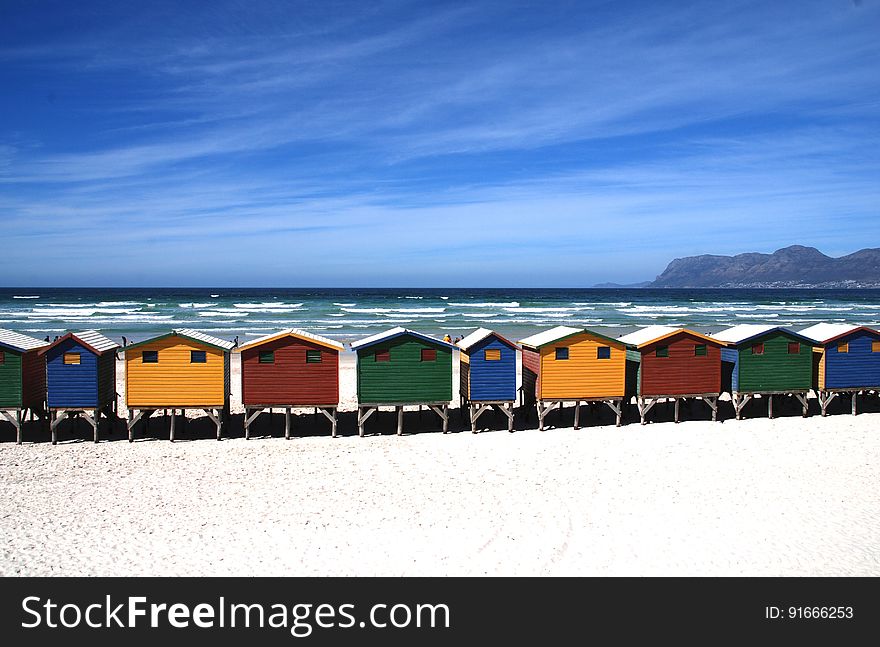 Colorful Cottages Near The Sea Under Blue Sky During Daytime