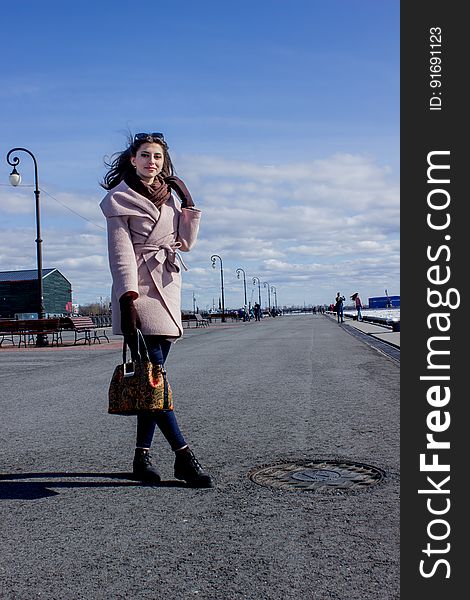 Beautiful young dark-haired girl on the waterfront.