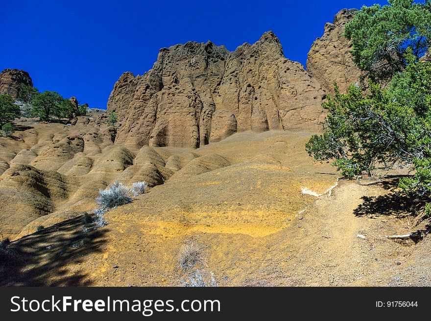 Red Mountain is a volcanic cinder cone that rises 1,000 feet above the surrounding landscape. It is unusual in having the shape of a &quot;U,&quot; and in lacking the symmetrical shape of most cinder cones. In addition, a large natural amphitheater cuts into the cone&#x27;s northeast flank. Erosional pillars called &quot;hoodoos&quot; decorate the amphitheater, and many dark mineral crystals erode out of its walls. Studies by U.S. Geological Survey &#x28;USGS&#x29; and Northern Arizona University scientists suggest that Red Mountain formed in eruptions about 740,000 years ago. The trailhead is located on U.S. Highway 180, 25 miles northwest of Flagstaff, Arizona. The trail is an easy 1.5 miles through open terrain with fantastic views of the San Francisco Peaks and surrounding San Francisco Volcanic Field. There is a short &#x28;approximately 6 feet&#x29; ladder climb required just before entering the natural amphitheater of the cinder cone. Photo by Deborah Lee Soltesz, February 2015. Credit: U.S. Forest Service, Coconino National Forest. For more information about this trail, see the Red Mountain Trail #159 trail description on the Coconino National Forest website. Red Mountain is a volcanic cinder cone that rises 1,000 feet above the surrounding landscape. It is unusual in having the shape of a &quot;U,&quot; and in lacking the symmetrical shape of most cinder cones. In addition, a large natural amphitheater cuts into the cone&#x27;s northeast flank. Erosional pillars called &quot;hoodoos&quot; decorate the amphitheater, and many dark mineral crystals erode out of its walls. Studies by U.S. Geological Survey &#x28;USGS&#x29; and Northern Arizona University scientists suggest that Red Mountain formed in eruptions about 740,000 years ago. The trailhead is located on U.S. Highway 180, 25 miles northwest of Flagstaff, Arizona. The trail is an easy 1.5 miles through open terrain with fantastic views of the San Francisco Peaks and surrounding San Francisco Volcanic Field. There is a short &#x28;approximately 6 feet&#x29; ladder climb required just before entering the natural amphitheater of the cinder cone. Photo by Deborah Lee Soltesz, February 2015. Credit: U.S. Forest Service, Coconino National Forest. For more information about this trail, see the Red Mountain Trail #159 trail description on the Coconino National Forest website.