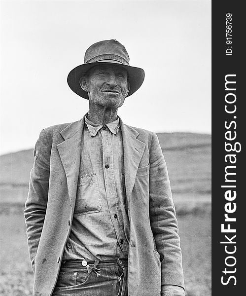 Grayscale Portrait Of A Man In Suit Jacket And Panama Hat