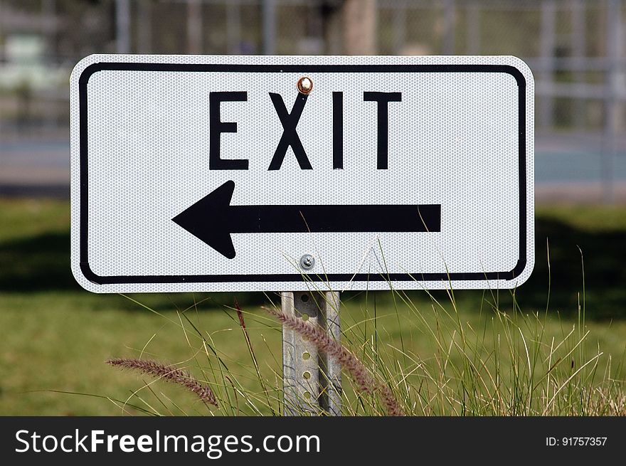 An exit sign with a pointing arrow.
