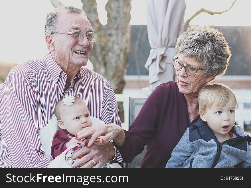 Grandparents sitting outdoor with their grandchildren. Grandparents sitting outdoor with their grandchildren.