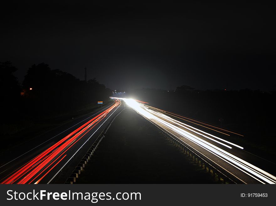 Time lapse view of motor car lights on highway at night.