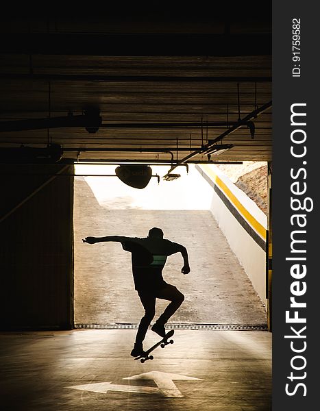 A silhouette of an underground skateboarder. A silhouette of an underground skateboarder.
