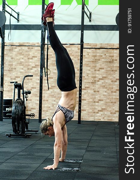 Athletic woman performing handstand