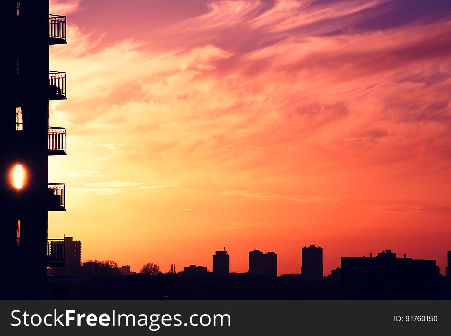 A view of an urban city with colorful sunset on the sky. A view of an urban city with colorful sunset on the sky.