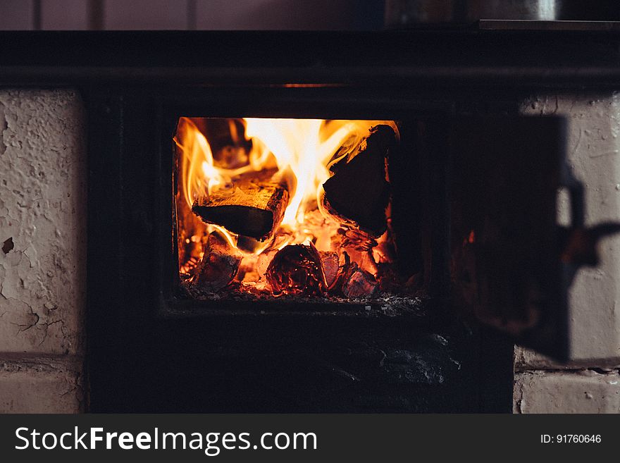 A wood-burning stove with a fire inside. A wood-burning stove with a fire inside.