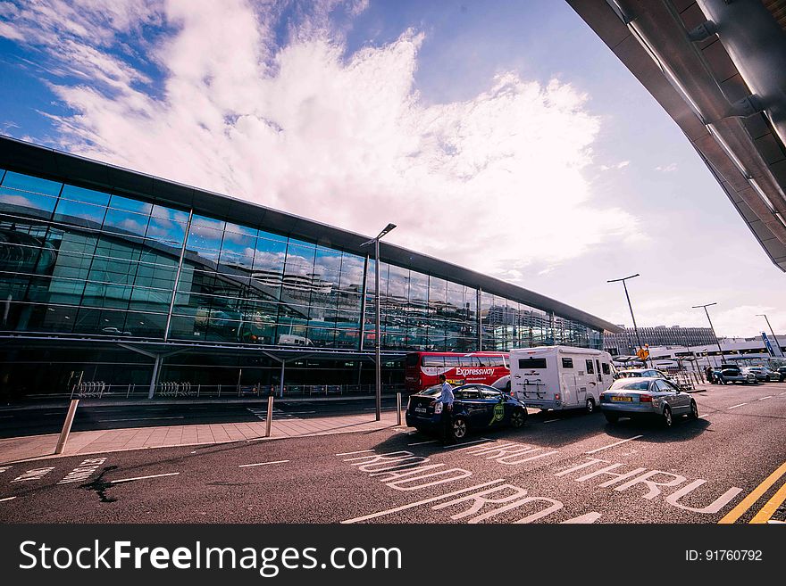 A parking lot next to an commercial building or airport terminal. A parking lot next to an commercial building or airport terminal.