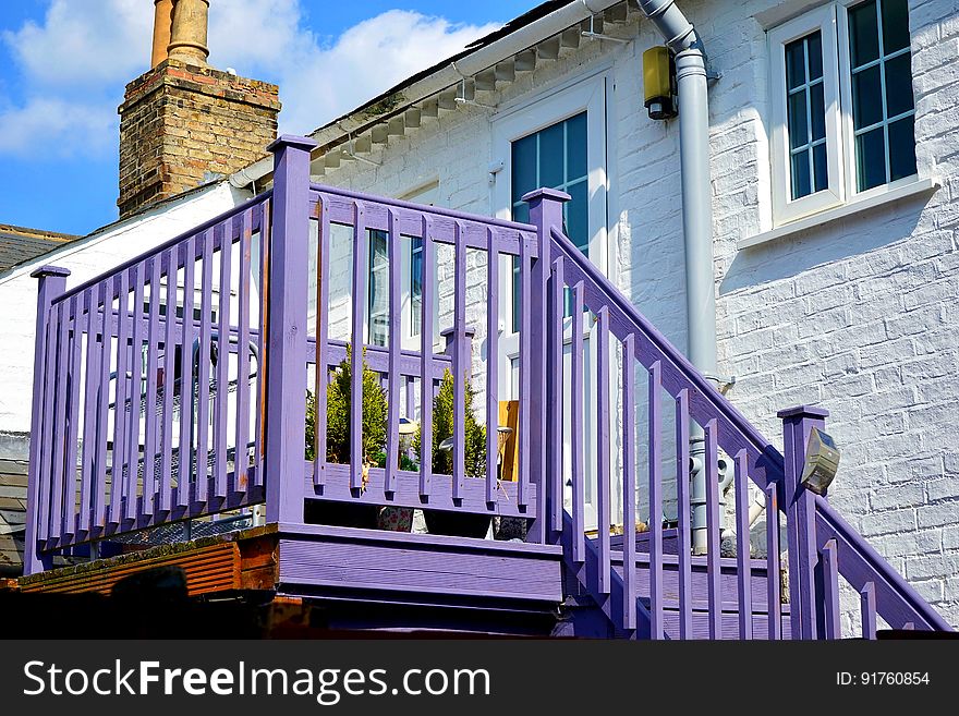 A stone house with violet balcony and stairs. A stone house with violet balcony and stairs.