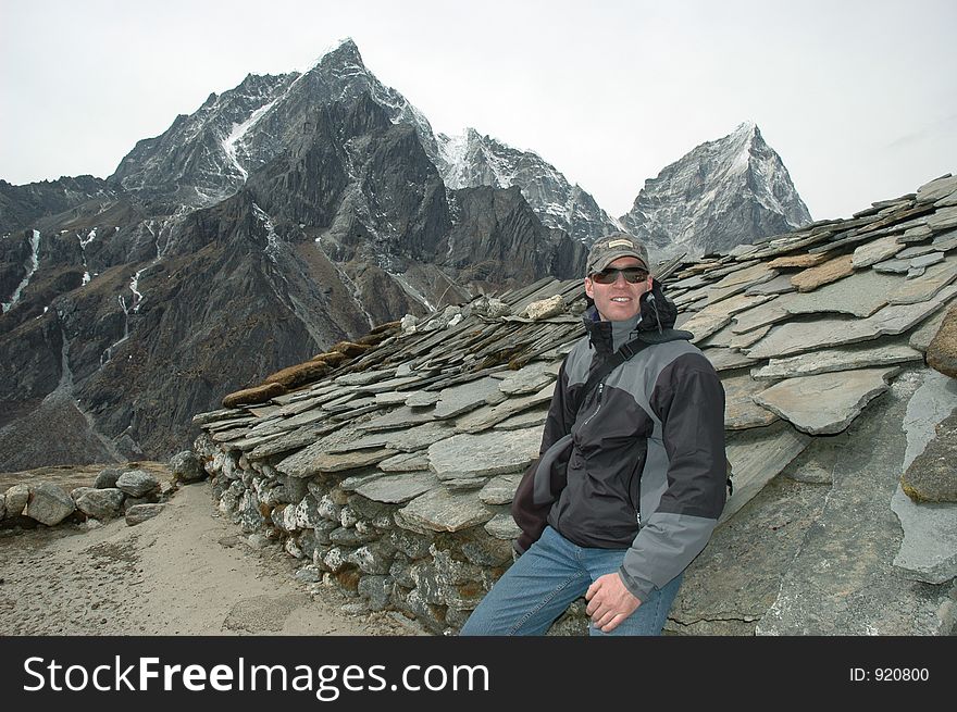 Trekker in the high Himalaya and Tavoche peak in the background