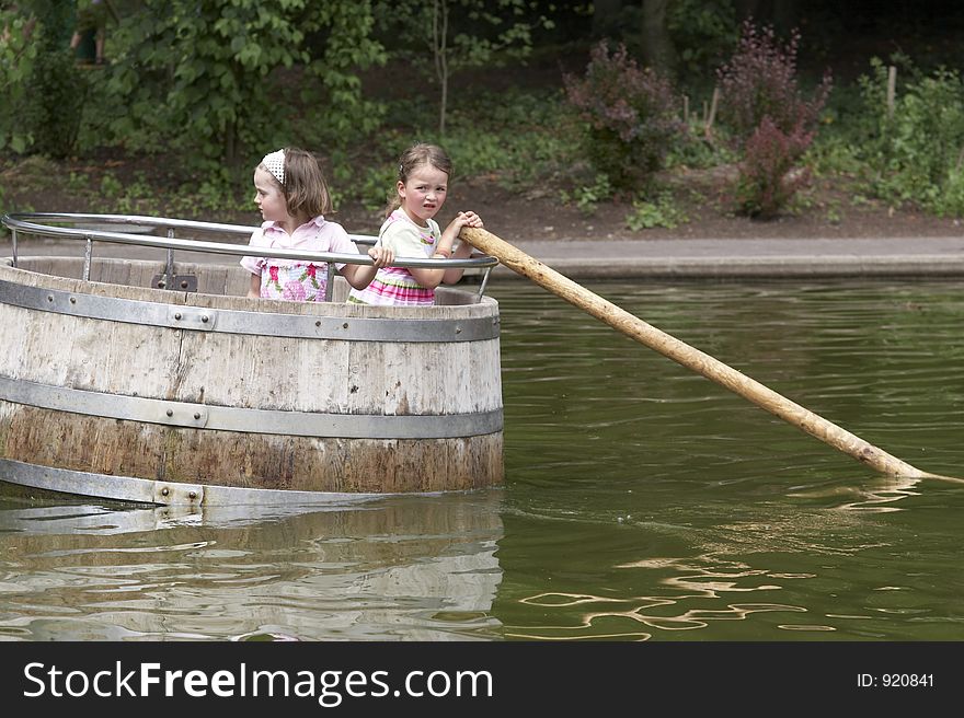 Twins playing in a barrel 03