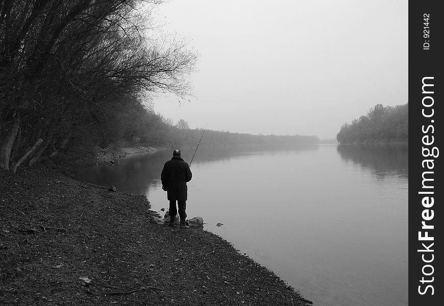 Fishing by the river on a cloudy day