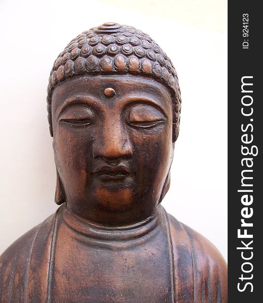 Close-up of Buddha ornament on a white background