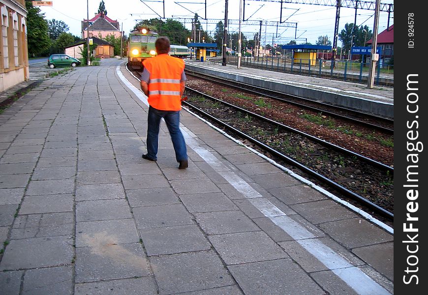 Train riding to railroad station and walking railwayman