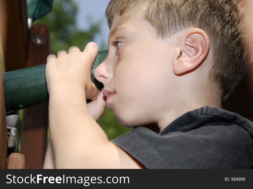Young Boy Looking Through a Telescope. Young Boy Looking Through a Telescope