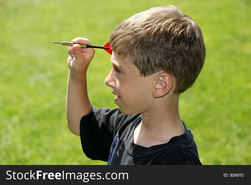 Child Holding a Dart. Child Holding a Dart