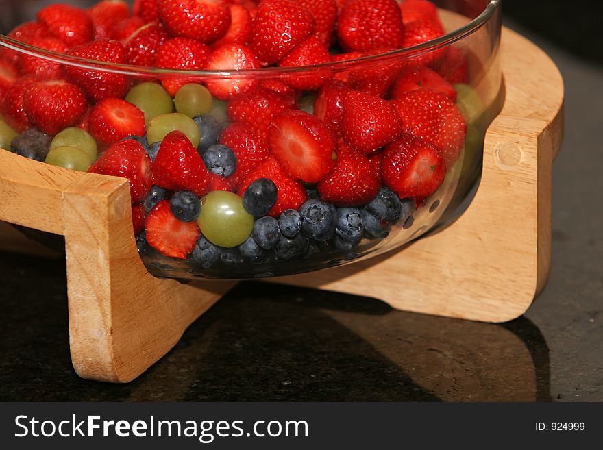 A bowl of fresh berries made for dessert, strawberries, blueberries and grapes. A bowl of fresh berries made for dessert, strawberries, blueberries and grapes