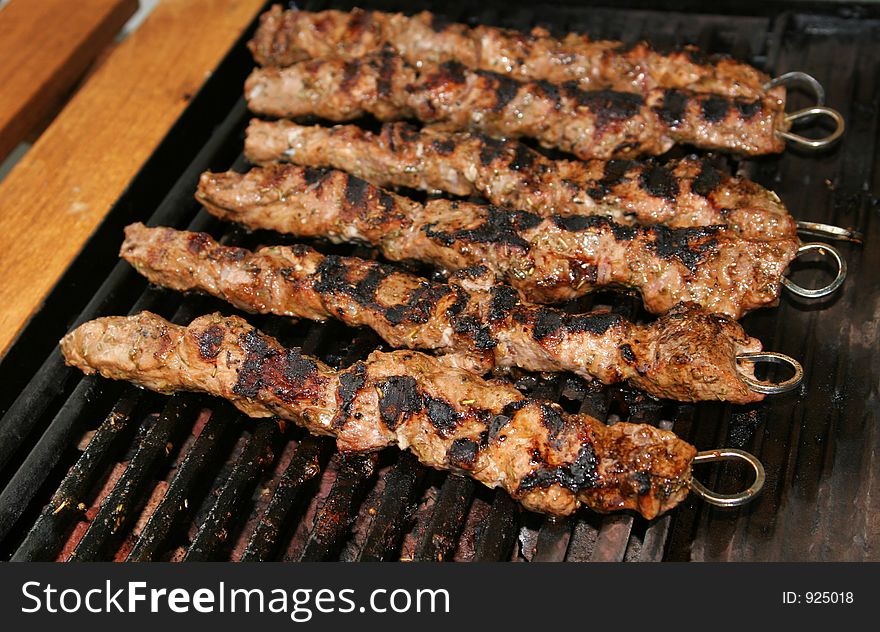 Meat being barbecued on a gas grill. Meat being barbecued on a gas grill