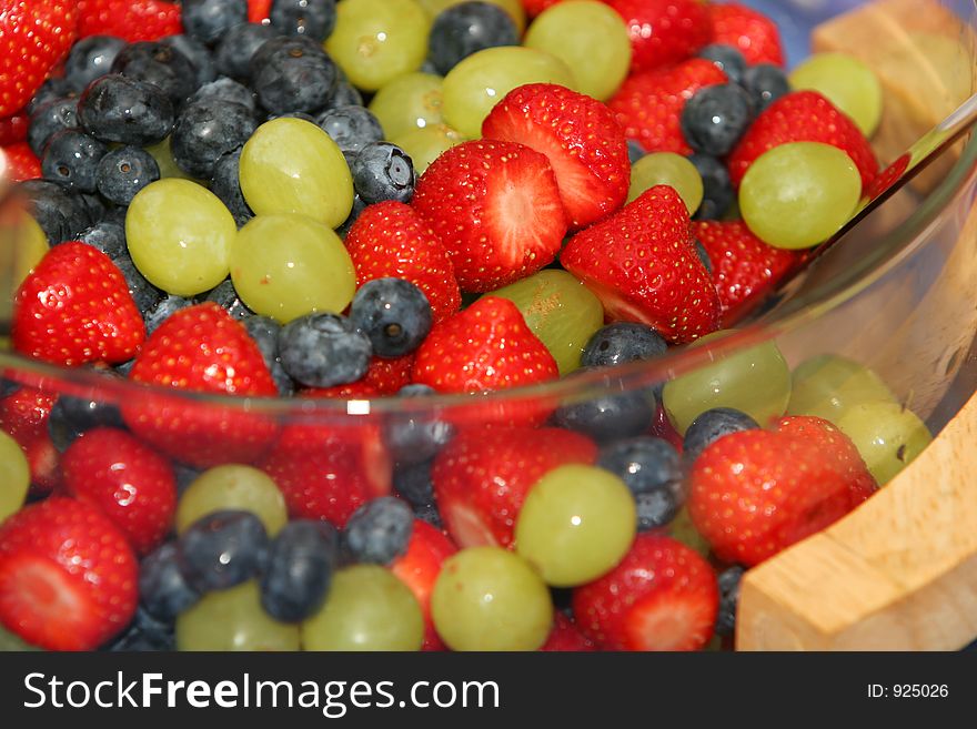 A dish of fresh berries, strawberries, blueberries, grapes. A dish of fresh berries, strawberries, blueberries, grapes