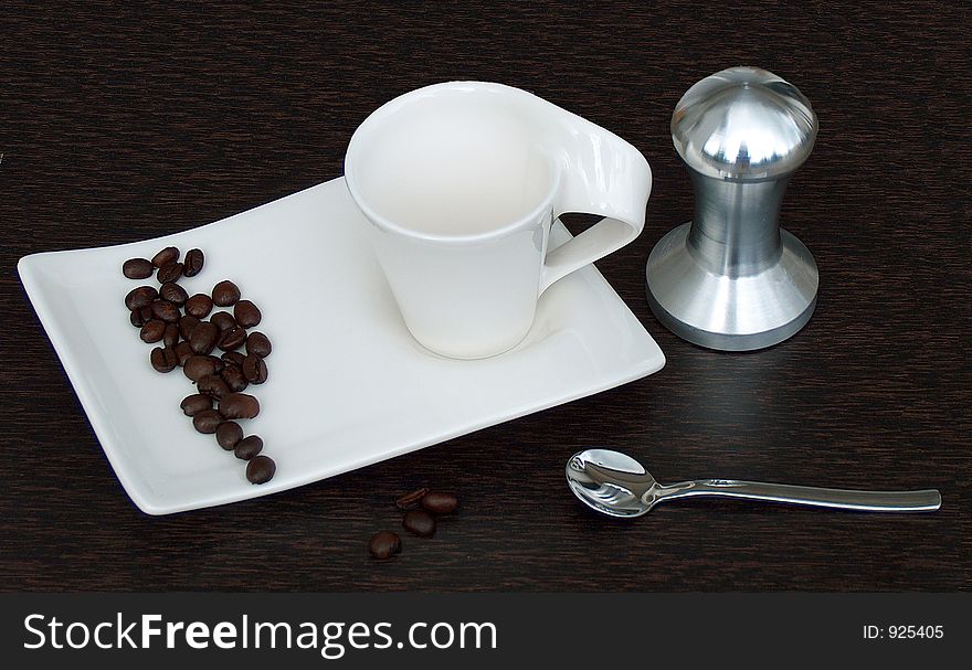 Mixture of elegant coffee cup with coffee beans and coffee press. Mixture of elegant coffee cup with coffee beans and coffee press