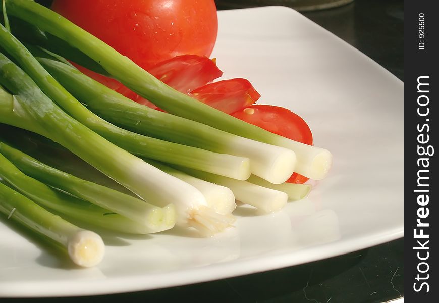 Chive and tomatos on a plate. Chive and tomatos on a plate