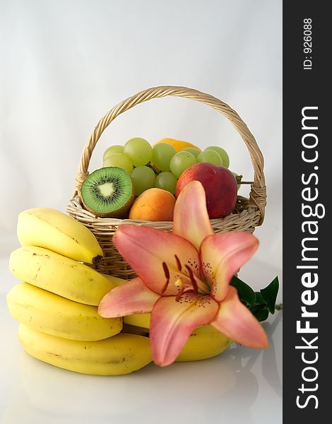 Fruit basket decorate with lily flower. Fruit basket decorate with lily flower