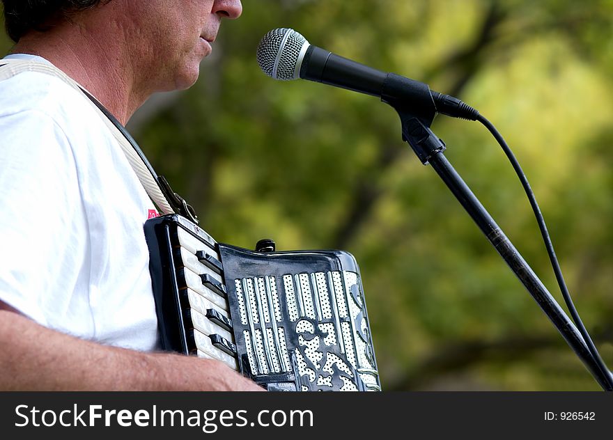 Man singing and playing a accordion
