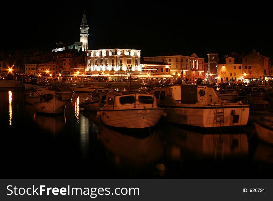 Small boats and mediterranean cityscape at night. Small boats and mediterranean cityscape at night.