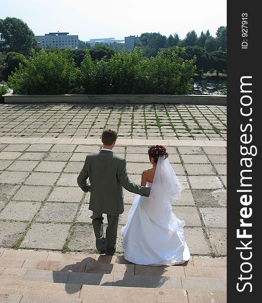 Newly wedded are walking down the street