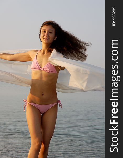 Beautiful young woman on the sea shore dancing. Beautiful young woman on the sea shore dancing
