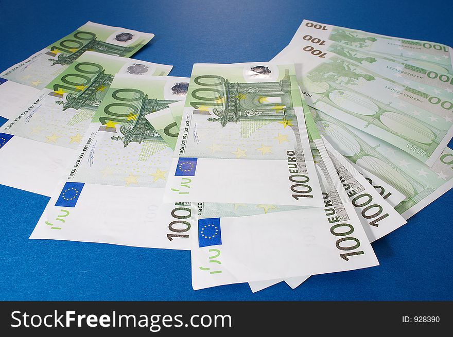 100 euro bills on blue background. 100 euro bills on blue background