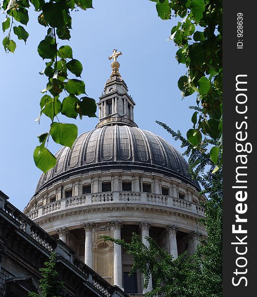 Saint Paul's Cathedral dome viewed through tree branches in the City of London