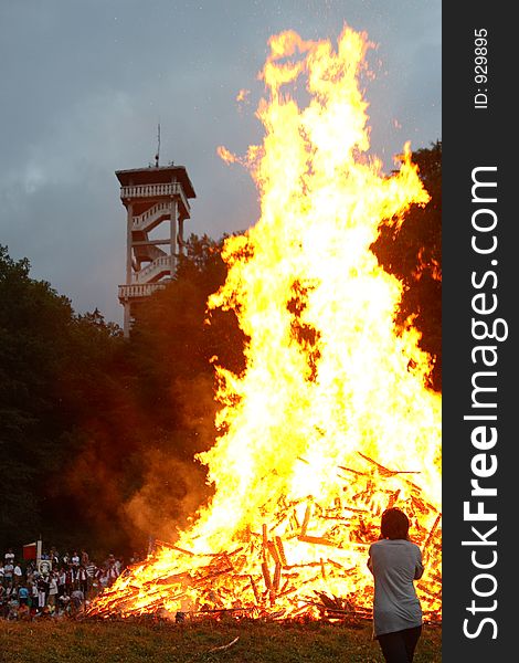 A person in front of Midsummer Night fire