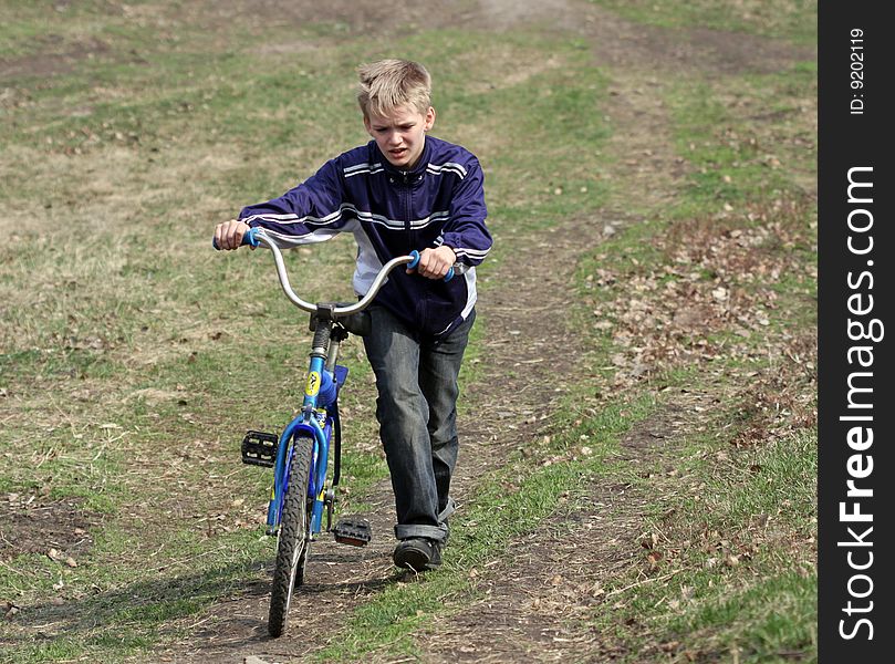 Boy uphill climbs by bike