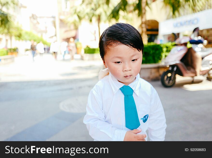 Chinese boy on the street in school uniform