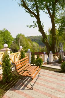 Wooden Bench In The Modern Spring Yard. Royalty Free Stock Photos Wooden Bench In The Modern Spring Yard. Royalty Free Stock Photos