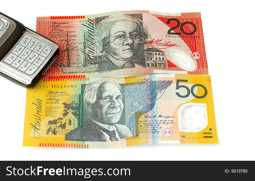 Mobile or cell phone next to Australian fifty and twenty dollar notes depicting the high costs of using a mobile telephone. Mobile or cell phone next to Australian fifty and twenty dollar notes depicting the high costs of using a mobile telephone
